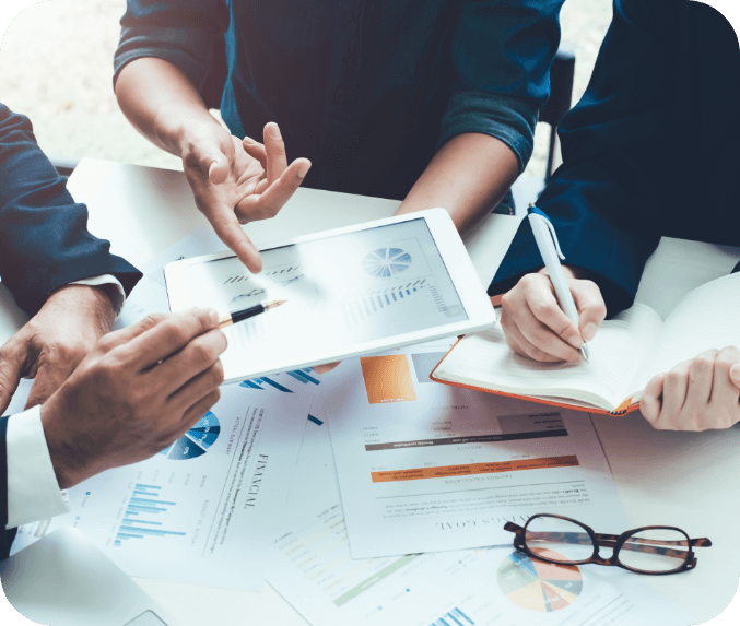 A group of people looking at stats on a tablet